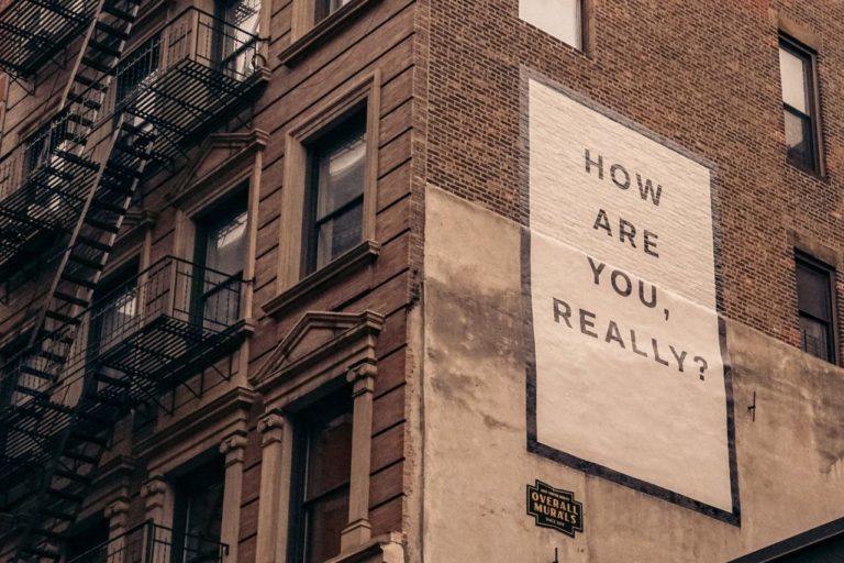 Brown Building with Sign "How Are You Really?"