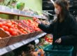 woman wearing mask and buying food in supermarket during coronavirus pandemic
