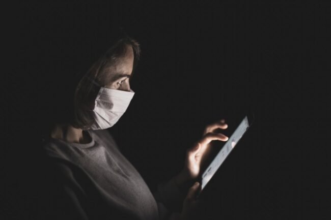 woman wearing mask on phone
